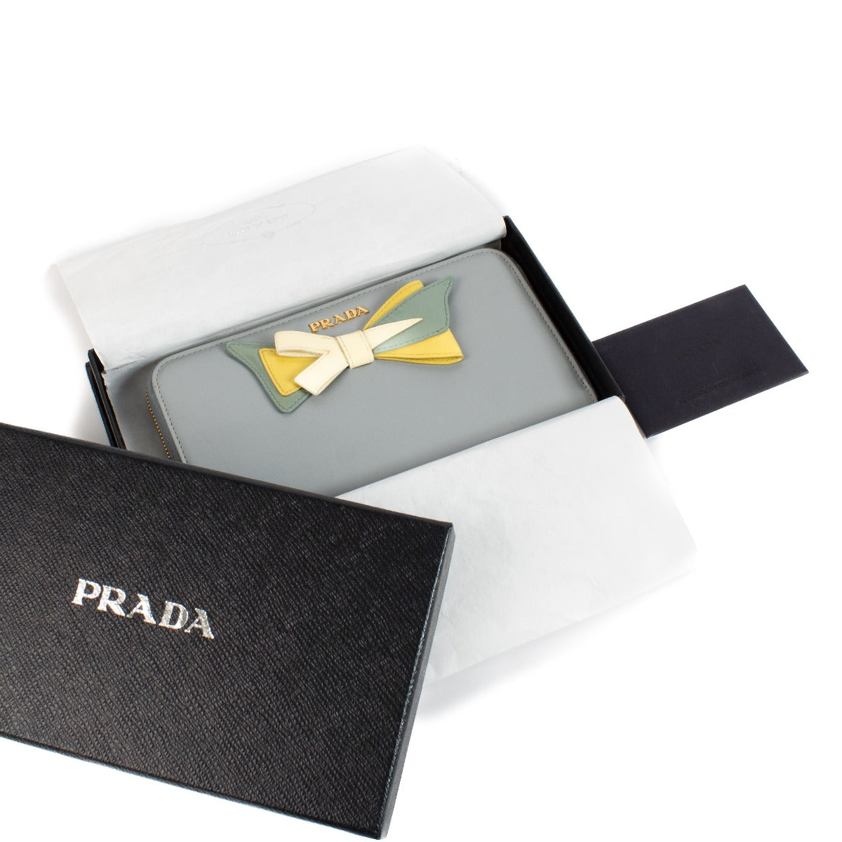 Shop safe online at Labellov in Antwerp, Brussels and Knokke this 100% authentic second hand Prada Blue Leather Bow Zip Around Wallet