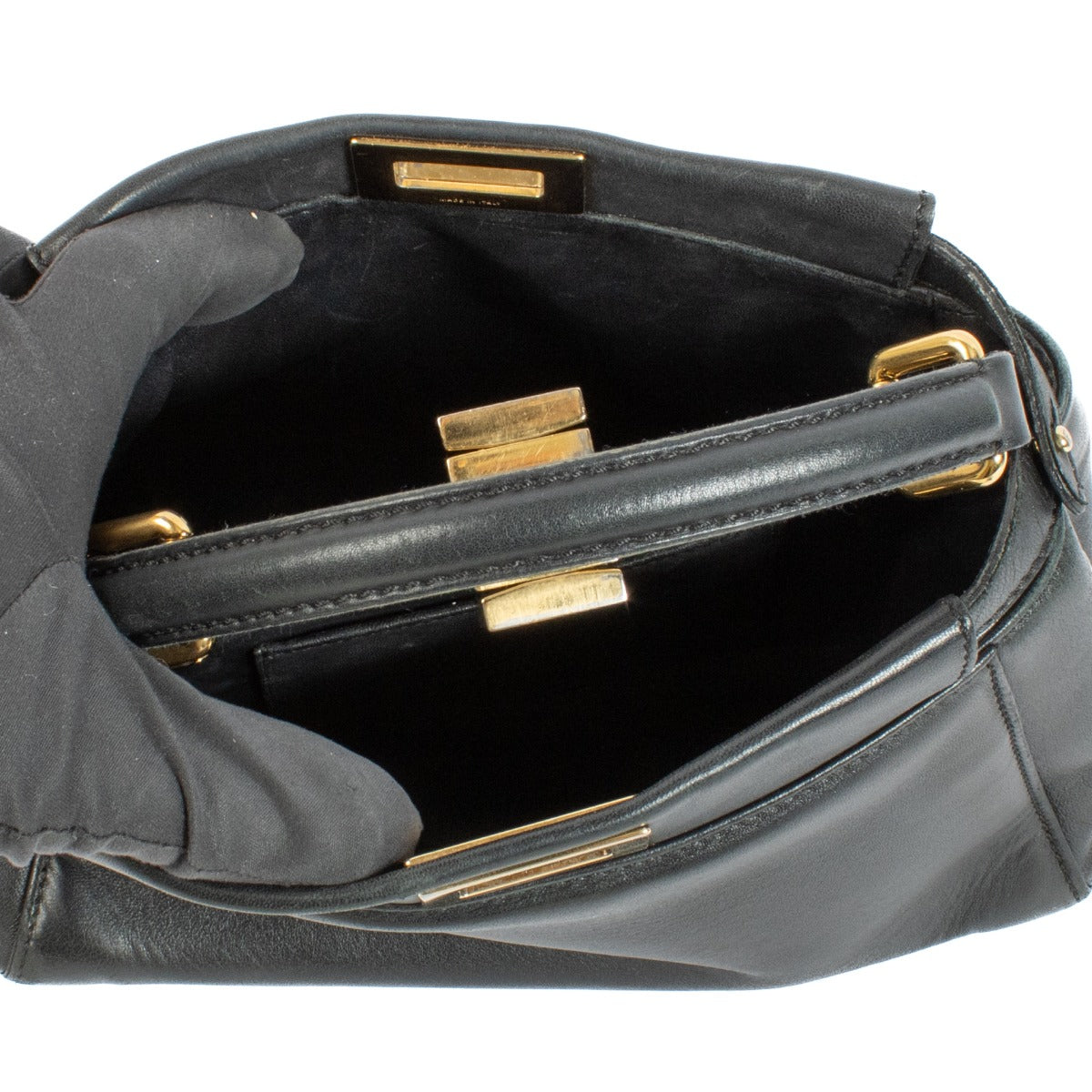 Discover the Fendi Black Mini Peekaboo Bag – a timeless luxury piece crafted from black leather with elegant gold hardware. Featuring a top handle and detachable strap, it's perfect for both everyday wear and evening outings. Shop this iconic designer han