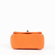 Shop this 100% authentic Chanel Orange Lambskin Mini Square Classic Bag at Labellov.com