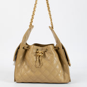 Chanel Classic Small Flap Bag 25 cm in beige caviar leather with gold hardware. A timeless Chanel icon in very good pre-loved condition.