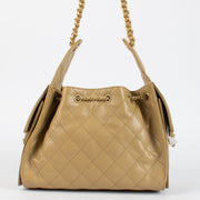 Chanel Classic Small Flap Bag 25 cm in beige caviar leather with gold hardware. A timeless Chanel icon in very good pre-loved condition.
