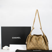 Chanel Classic Small Flap Bag 25 cm in beige caviar leather with gold hardware. A timeless Chanel icon in very good pre-loved condition.