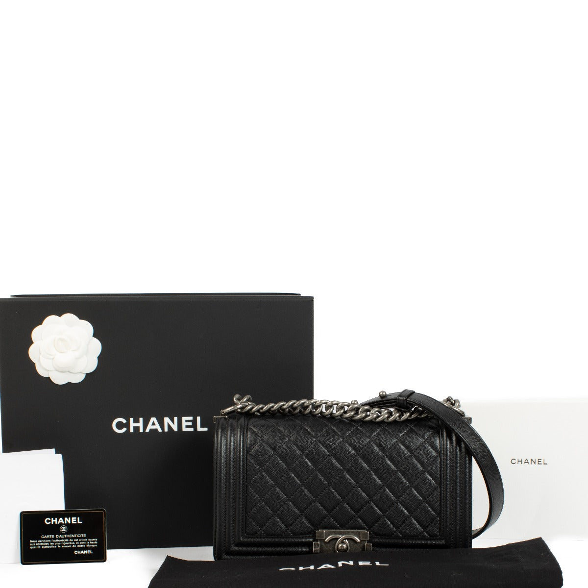 Chanel Boy Bag in black, featuring quilted leather, a signature push-lock closure, and a chunky chain strap. Shop now on Labellov.com.