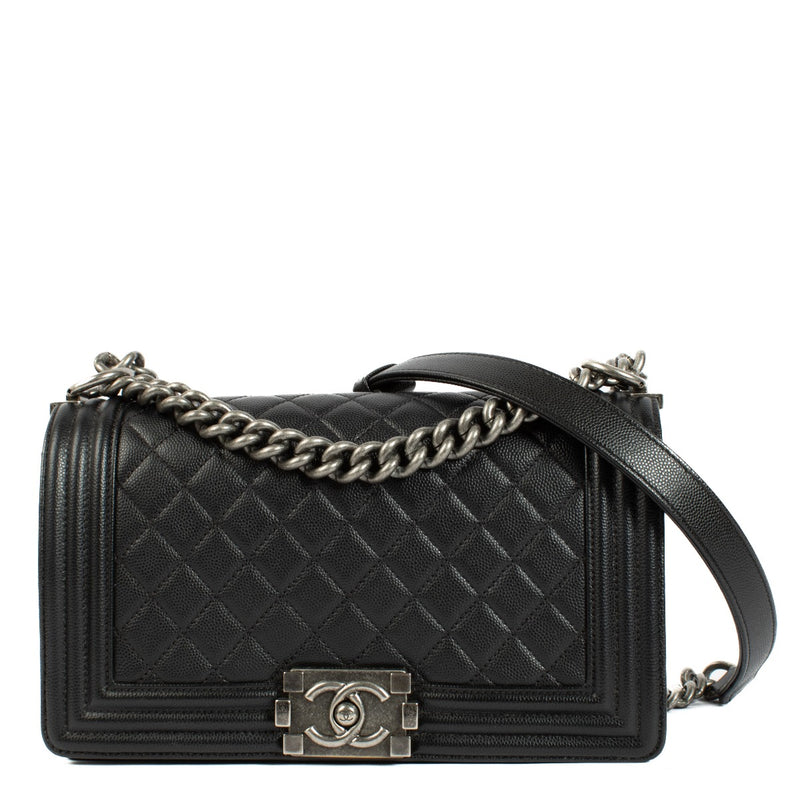 Chanel Boy Bag in black, featuring quilted leather, a signature push-lock closure, and a chunky chain strap. Shop now on Labellov.com.