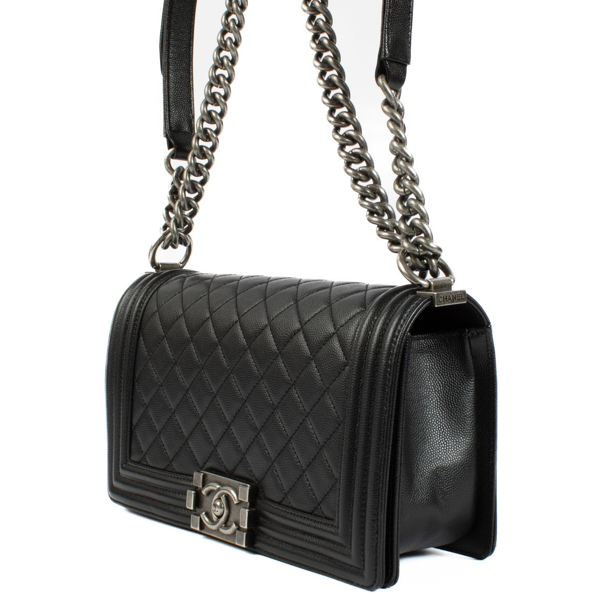Chanel Boy Bag in black, featuring quilted leather, a signature push-lock closure, and a chunky chain strap. Shop now on Labellov.com.