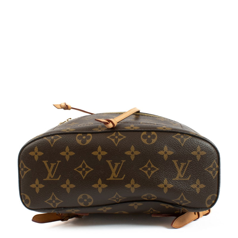 The Louis Vuitton Monogram Montsouris Backpack features the iconic LV monogram canvas with natural leather trim, a drawstring closure with a buckle flap, and adjustable leather straps for comfort. Its spacious interior and front zip pocket offer practical
