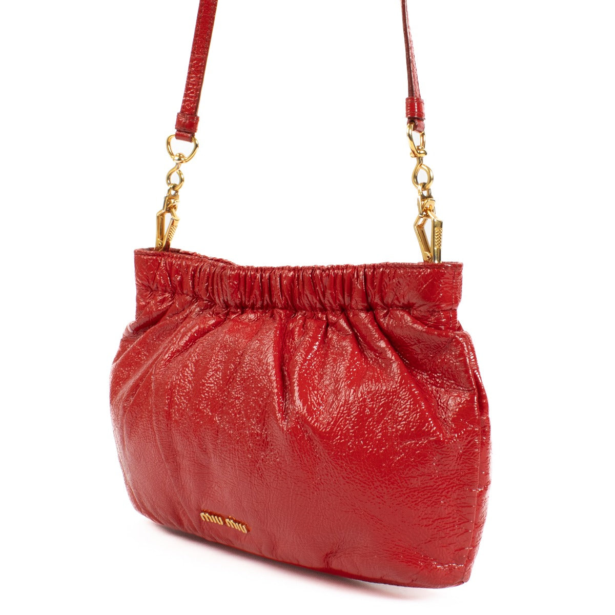 The Miu Miu Red Shoulder Bag in glossy red leather features gold hardware and the iconic Miu Miu logo on the front. Its pouch shape adds a modern, chic touch to the design. Shop now at Labellov.