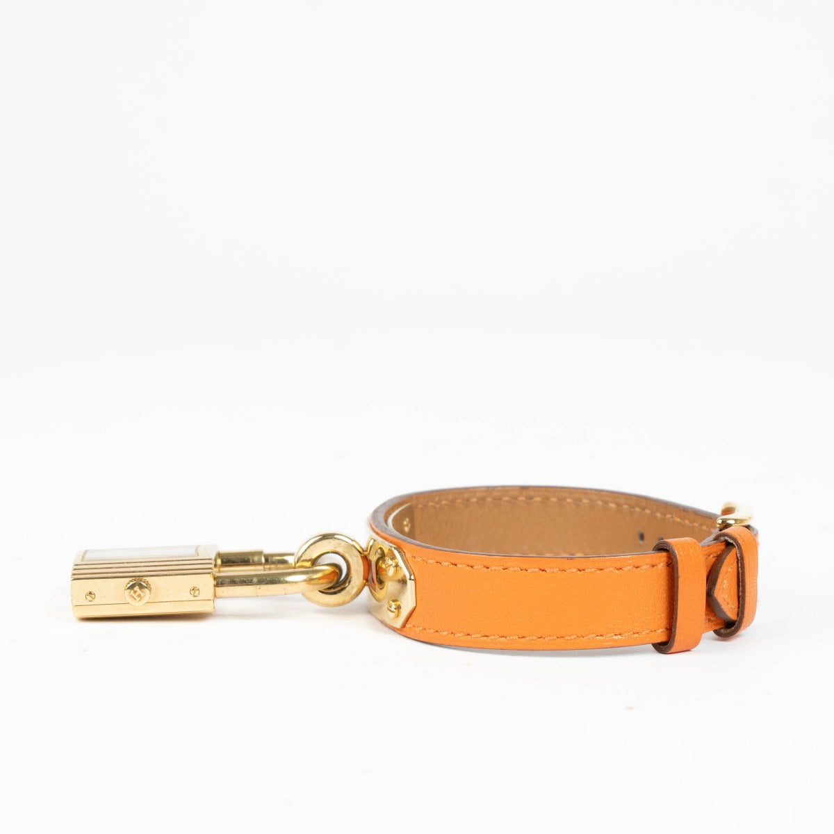 Shop this 100% authentic Hermès Gold Kelly Watch with orange strap at Labellov.com