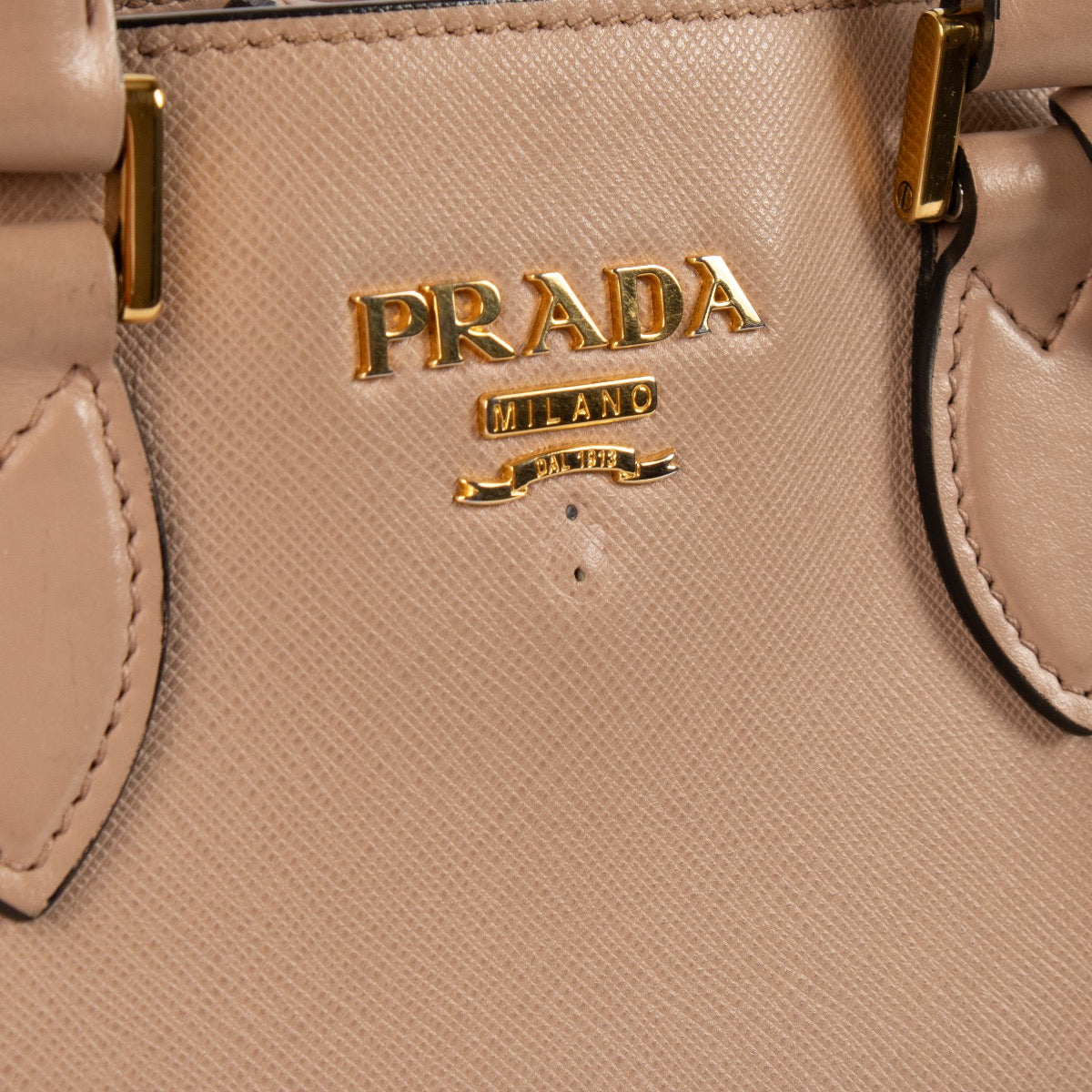 Shop safe online at Labellov in Antwerp, Brussels and Knokke this 100% authentic second hand Prada Beige Saffiano Top Handle Bag.