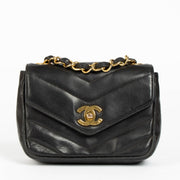 Shop this 100% authentic Chanel Black Lambskin Leather Mini Chevron Flap Bag at labellov.com.