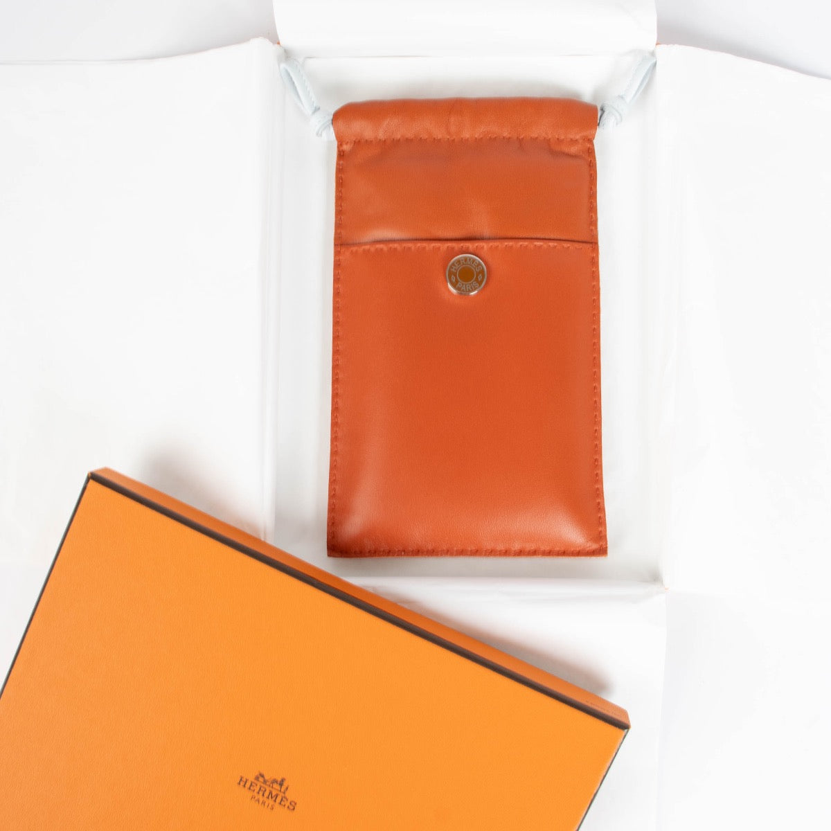 Authentic pre-loved Hermès Cornaline/Bleu Brume Etui Telephone Pilo on Labellov.com