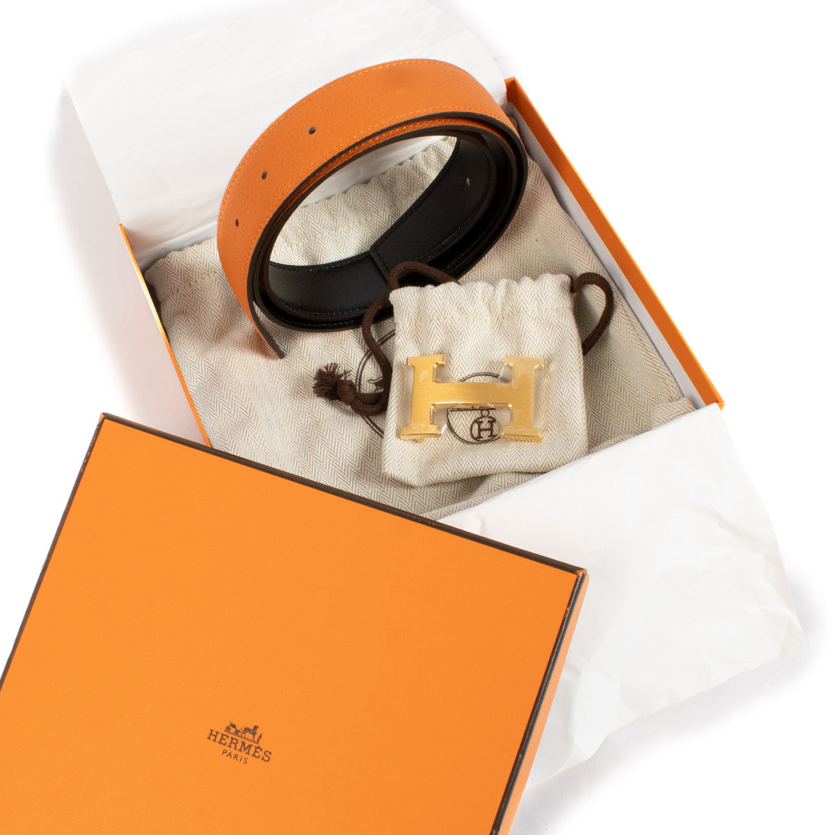 Featuring Hermès’ signature “H” buckle in a polished finish, this belt is reversible, offering two classic color options—vibrant orange on one side and sleek black on the other. Effortlessly transition from bold and playful to understated elegance, depend