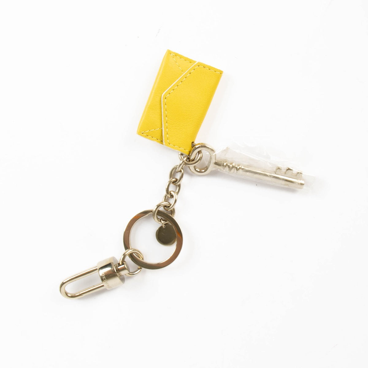 shop safe online at Labellov in Antwerp, Brussels and Knokke this 100% authentic second hand Delvaux Yellow Envelope Key Charm