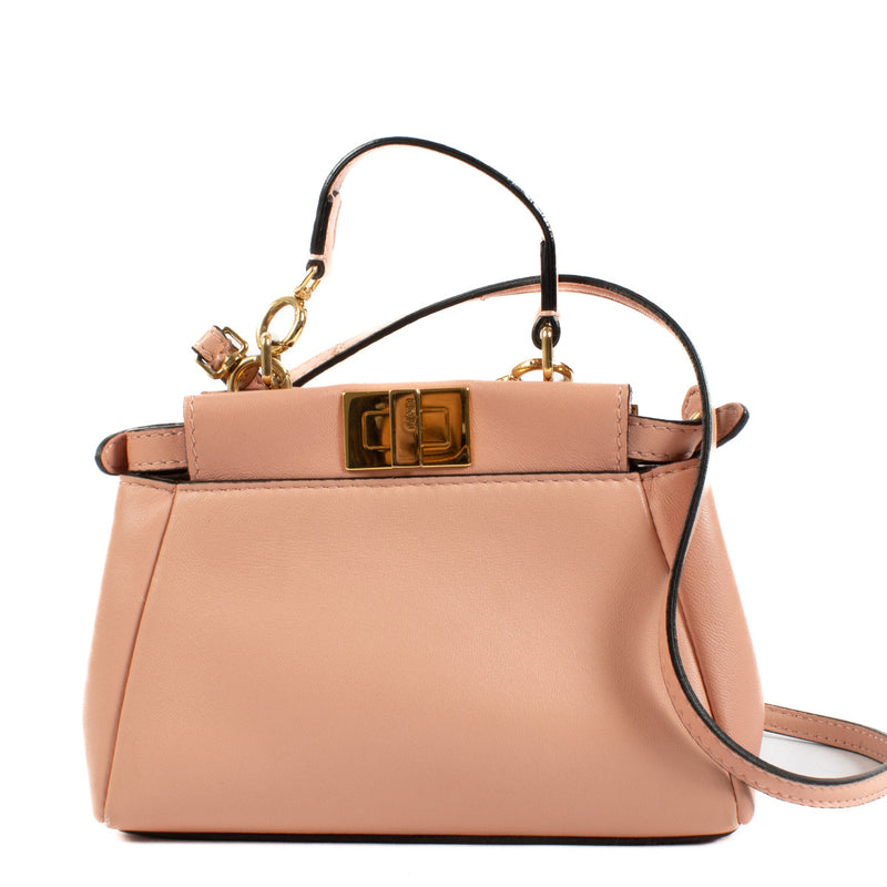 Playful yet sophisticated, this Fendi Pink Micro Peekaboo Bag is the perfect pop of color for your wardrobe. Crafted from smooth leather in a soft pink hue, this miniature version of Fendi’s iconic Peekaboo design is both charming and versatile.