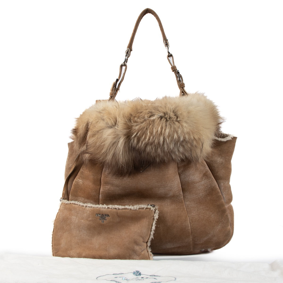Shop safe online at Labellov in Antwerp, Brussels and Knokke this 100% authentic second hand Prada Beige Shearling/Fox Hobo Shoulder Bag.