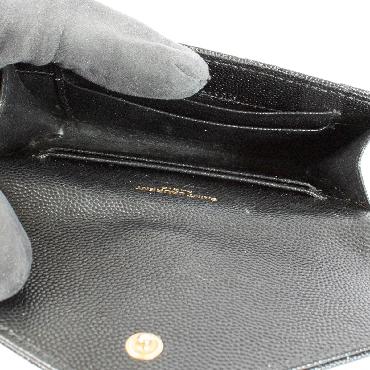 Shop the pre-loved Saint Laurent Black Cassandre Wallet in grained leather with gold YSL logo. A sleek designer essential, now available at Labellov in Antwerpen and Knokke.