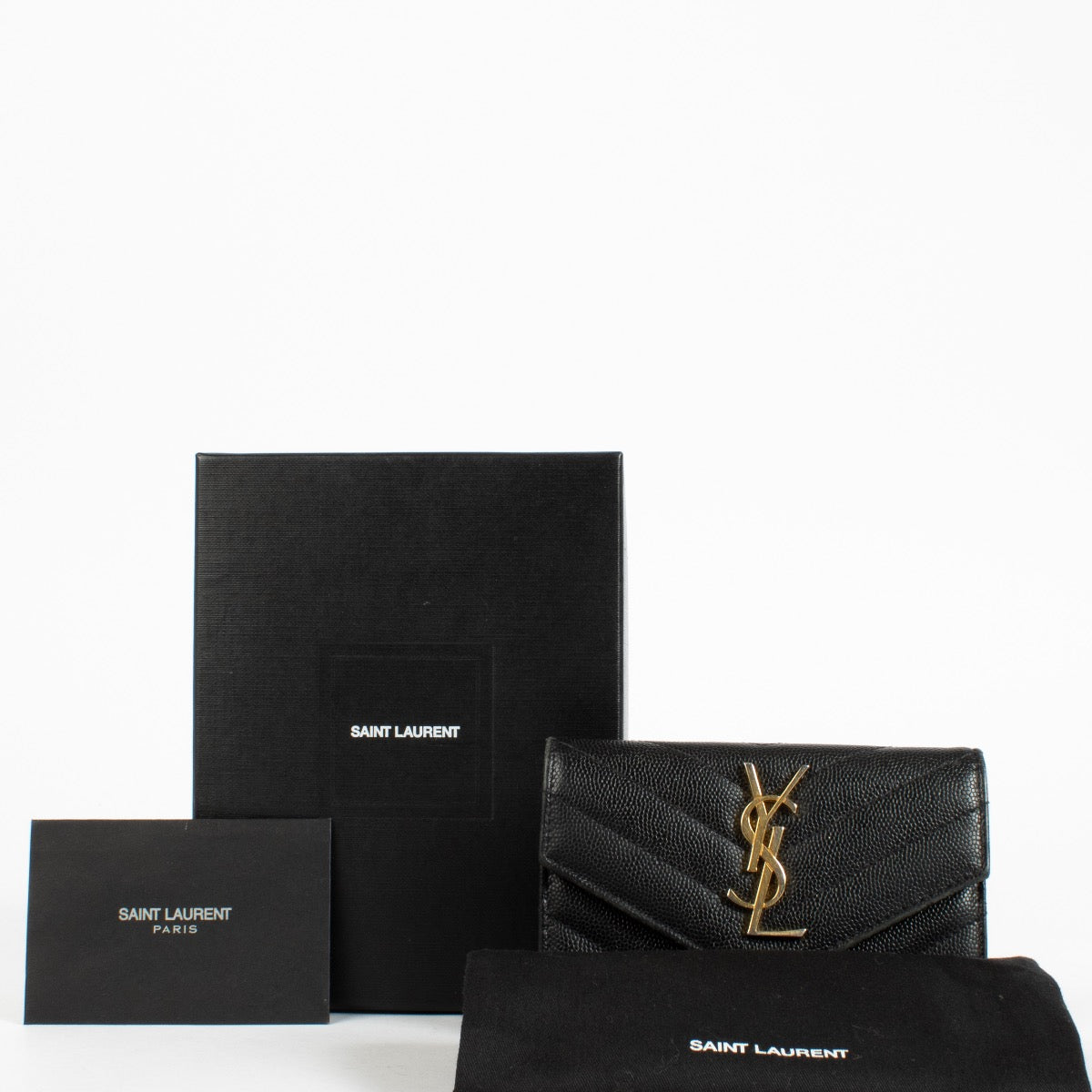 Shop the pre-loved Saint Laurent Black Cassandre Wallet in grained leather with gold YSL logo. A sleek designer essential, now available at Labellov in Antwerpen and Knokke.