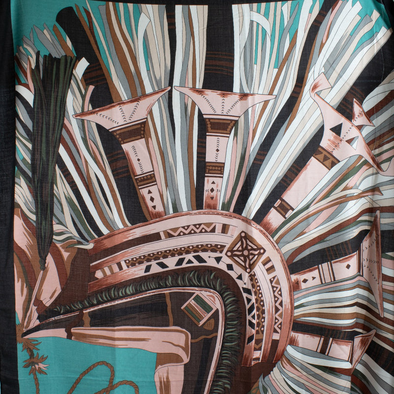 This Hermès scarf features a rose-colored background with turquoise, rose, green, and brown patterns. Made from high-quality silk, it adds a pop of color and sophistication to any outfit. Shop now on Labellov.com