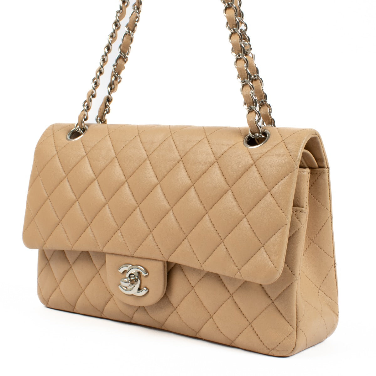 The Chanel Beige Lambskin Medium Classic 11.12 Bag exudes timeless elegance with its buttery-soft lambskin leather, gold-tone hardware, and iconic turn-lock closure. A must-have luxury piece. Shop now on Labellov.com.