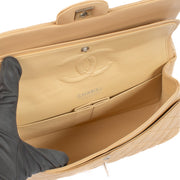 The Chanel Beige Lambskin Medium Classic 11.12 Bag exudes timeless elegance with its buttery-soft lambskin leather, gold-tone hardware, and iconic turn-lock closure. A must-have luxury piece. Shop now on Labellov.com.