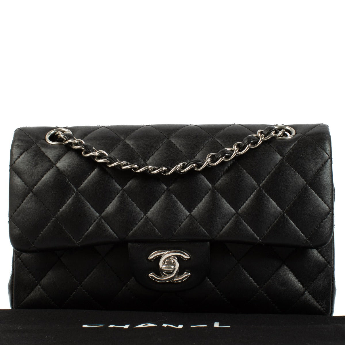 Chanel Black Lambskin Small Classic Bag with silver-tone hardware and turnlock closure, showcasing a smooth, elegant finish. Shop now on Labellov.com.