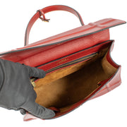 Delvaux Rosso Canter Saphir Bag in rich red leather with a structured silhouette, top handle, and gold-tone hardware. Stylish and functional for any occasion. Buy at Labellov.