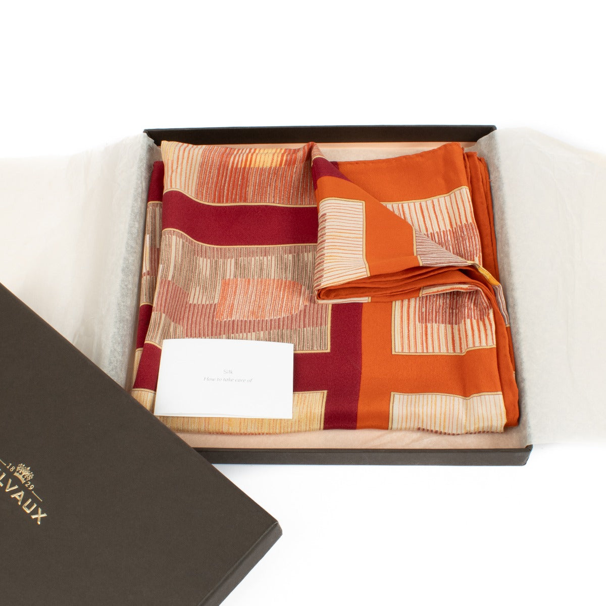 Delvaux Orange Dédicace Carre Silk Scarf – a luxurious silk scarf with vibrant orange tones and intricate detailing, perfect for adding elegance to any look. Buy now at Labellov.