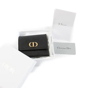 Christian Dior Black Leather 30 Montaigne Wallet with gold-tone logo hardware. Shop at Labellov.