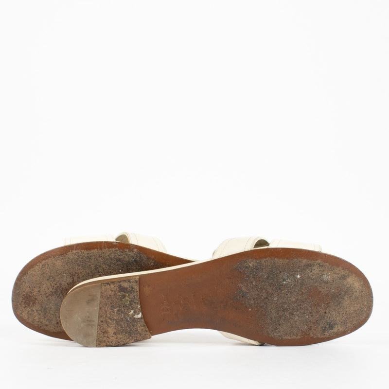 Shop pre-loved Christian Dior White Sandals featuring gold CD logo and smooth calfskin leather. A chic summer essential available now at Labellov, your trusted destination for luxury designer shoes in Antwerpen and Knokke.