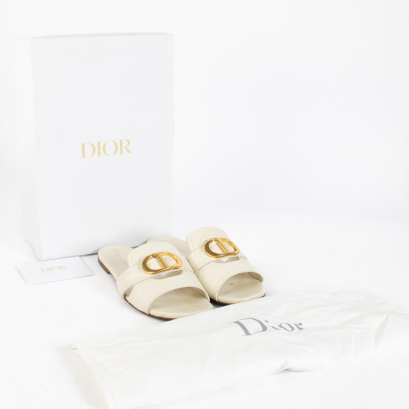 Shop pre-loved Christian Dior White Sandals featuring gold CD logo and smooth calfskin leather. A chic summer essential available now at Labellov, your trusted destination for luxury designer shoes in Antwerpen and Knokke.