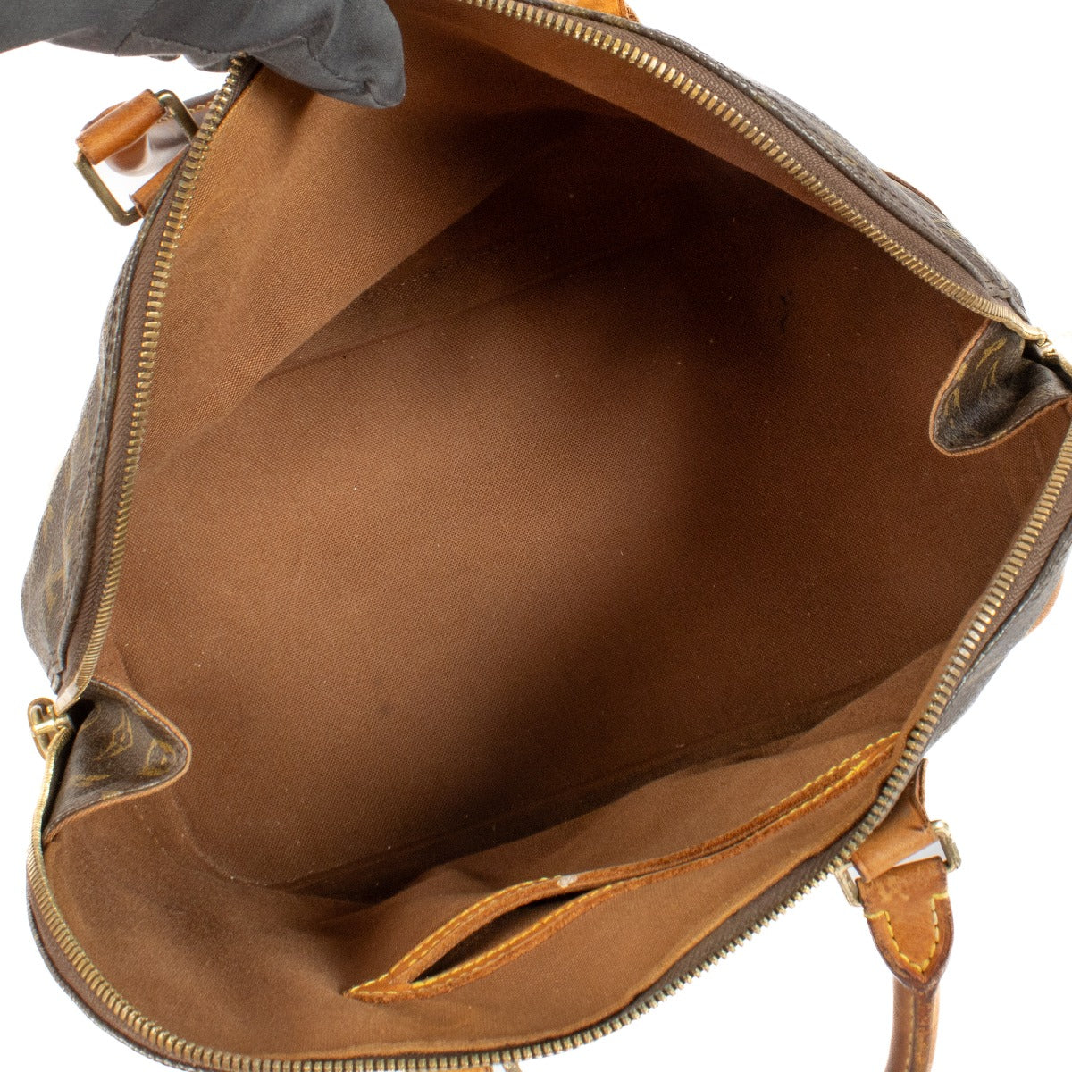 Louis Vuitton Vintage Monogram Alma PM bag with vachetta leather handles, showing signs of use and darkened patina. Classic structured silhouette with brass hardware. Shop at Labellov.