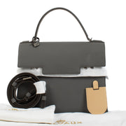 Delvaux Stone Crispy Calf Tempête MM bag in premium crispy calf leather, featuring a sophisticated stone hue, modern design, and versatile size with dust bag and extra strap. Shop now on Labellov.com.