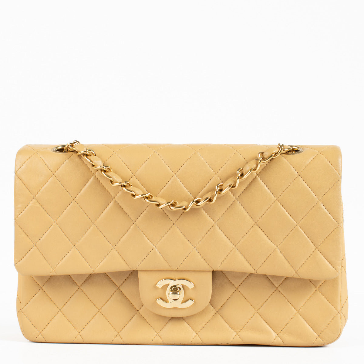 An exquisite example of timeless Chanel elegance, this Chanel Vintage Classic Flap Bag is crafted in beige quilted lambskin leather, offering a refined alternative to the traditional black. T