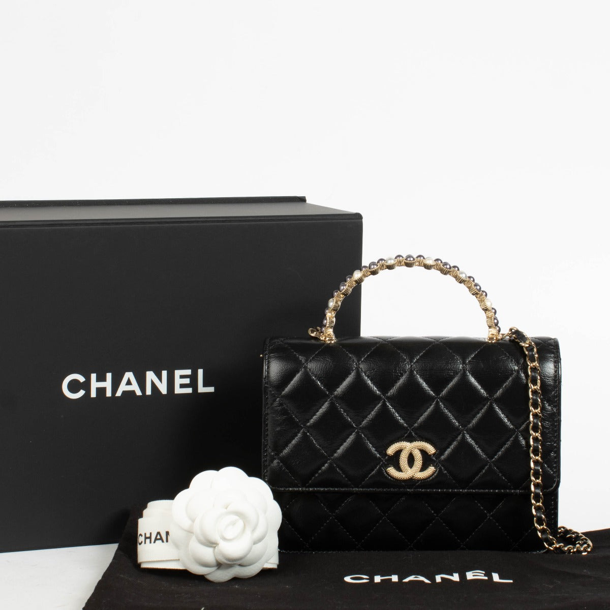 Authentic pre-loved Chanel Black Lambskin Pearl Top Handle Clutch With Chain on Labellov.com