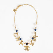 Authentic Chanel gold-tone letter necklace with crystals, pearls and CC logo charm at Labellov.com.