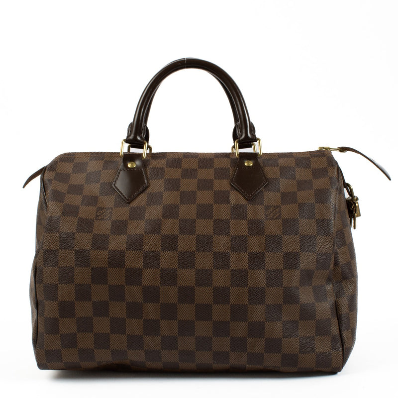 The Louis Vuitton Damier Ebene Speedy 30 is a classic, spacious handbag crafted from signature brown canvas with leather handles and gold-tone hardware. Its timeless design and functional size make it perfect for everyday use or travel. Shop now on Labell