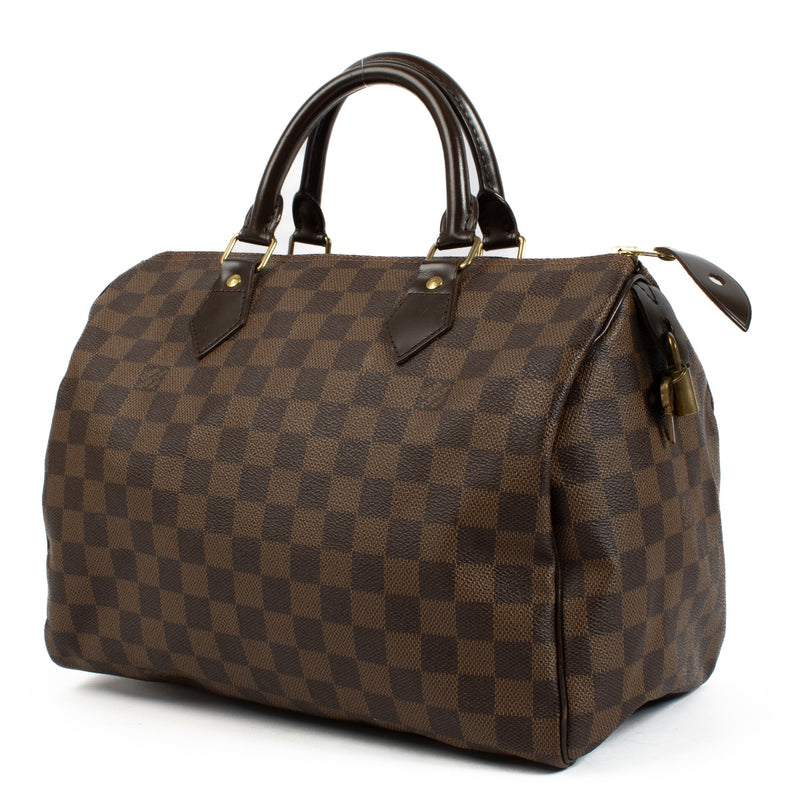 The Louis Vuitton Damier Ebene Speedy 30 is a classic, spacious handbag crafted from signature brown canvas with leather handles and gold-tone hardware. Its timeless design and functional size make it perfect for everyday use or travel. Shop now on Labell