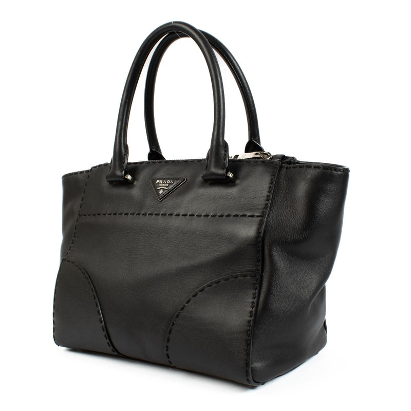 Prada Black City Calf Handbag in luxurious black calf leather, featuring a minimalist design, top handles, adjustable shoulder strap, and spacious interior. Shop now on Labellov.com.