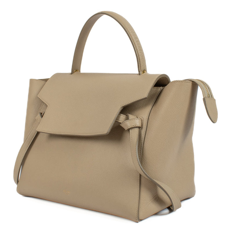 The Celine Beige Mini Belt Bag is a chic and compact leather accessory featuring a structured design, belt buckle closure, and detachable shoulder strap, perfect for day-to-night wear. Shop now on Labellov.com.
