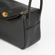 Shop this 100% authentic Hermès Lindy 26 Black Clemence GHW Top Handle Bag at Labellov.com