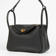 Shop this 100% authentic Hermès Lindy 26 Black Clemence GHW Top Handle Bag at Labellov.com
