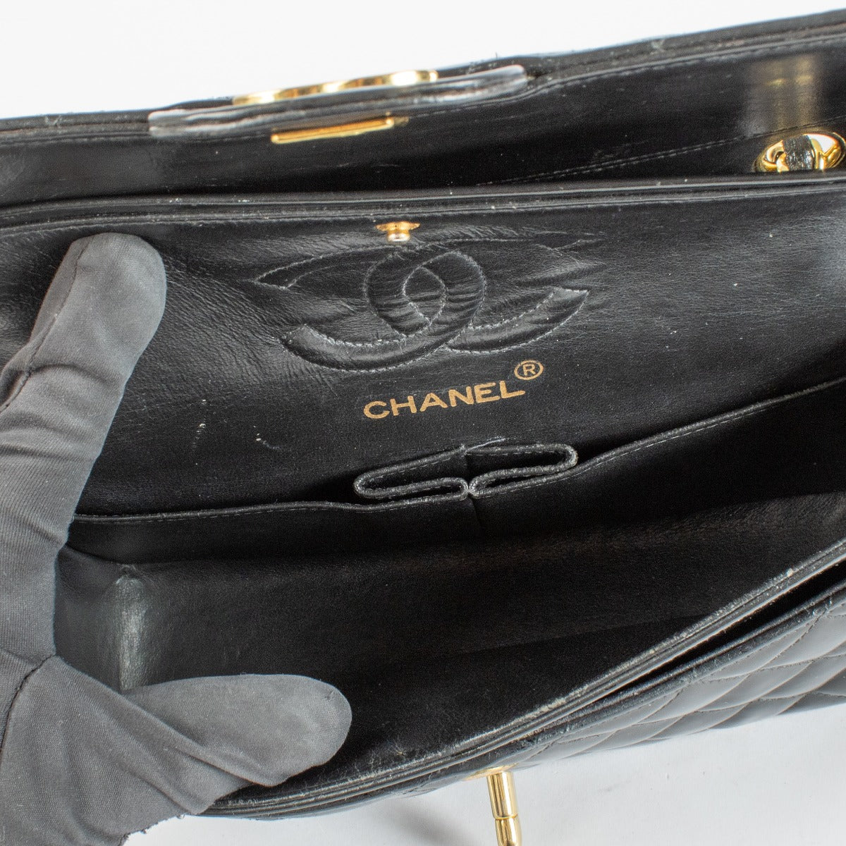 Shop the Chanel Classic Double Flap Bag in black patent leather with gold hardware at Labellov.com