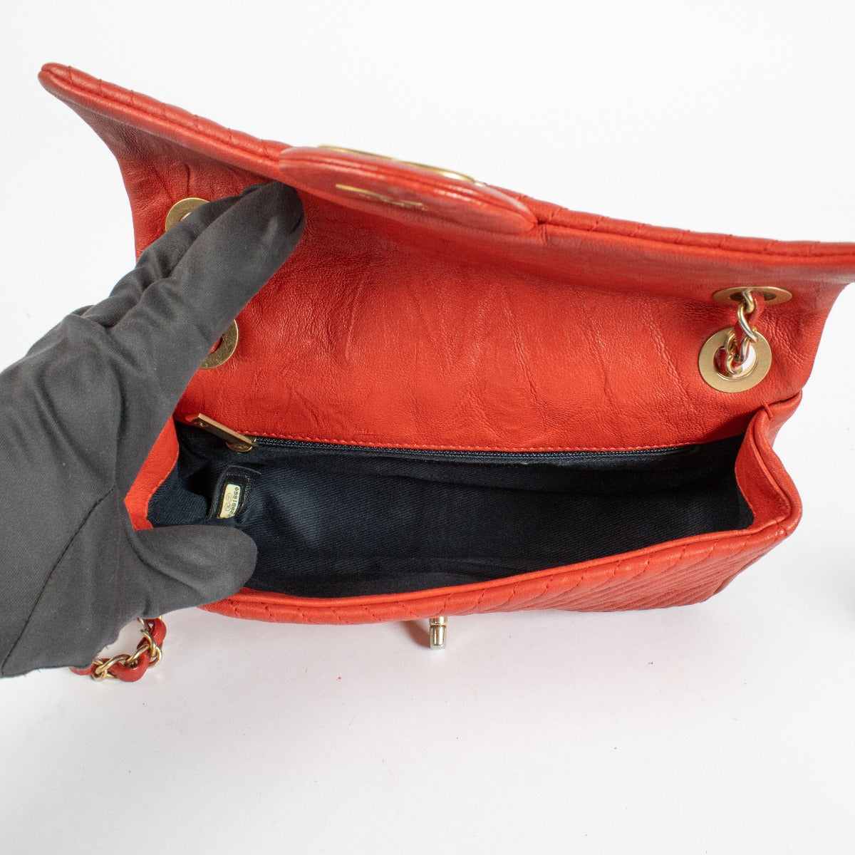 Authentic pre-loved Chanel Red Chevron Wrinkled Goatskin Medallion Mini Flap Bag on Labellov.com