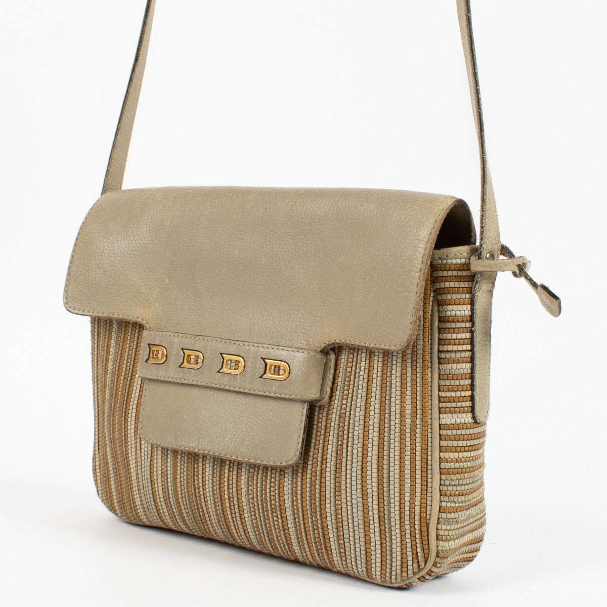 Side view of vintage Delvaux crossbody bag highlighting patina and elegant minimalist design.