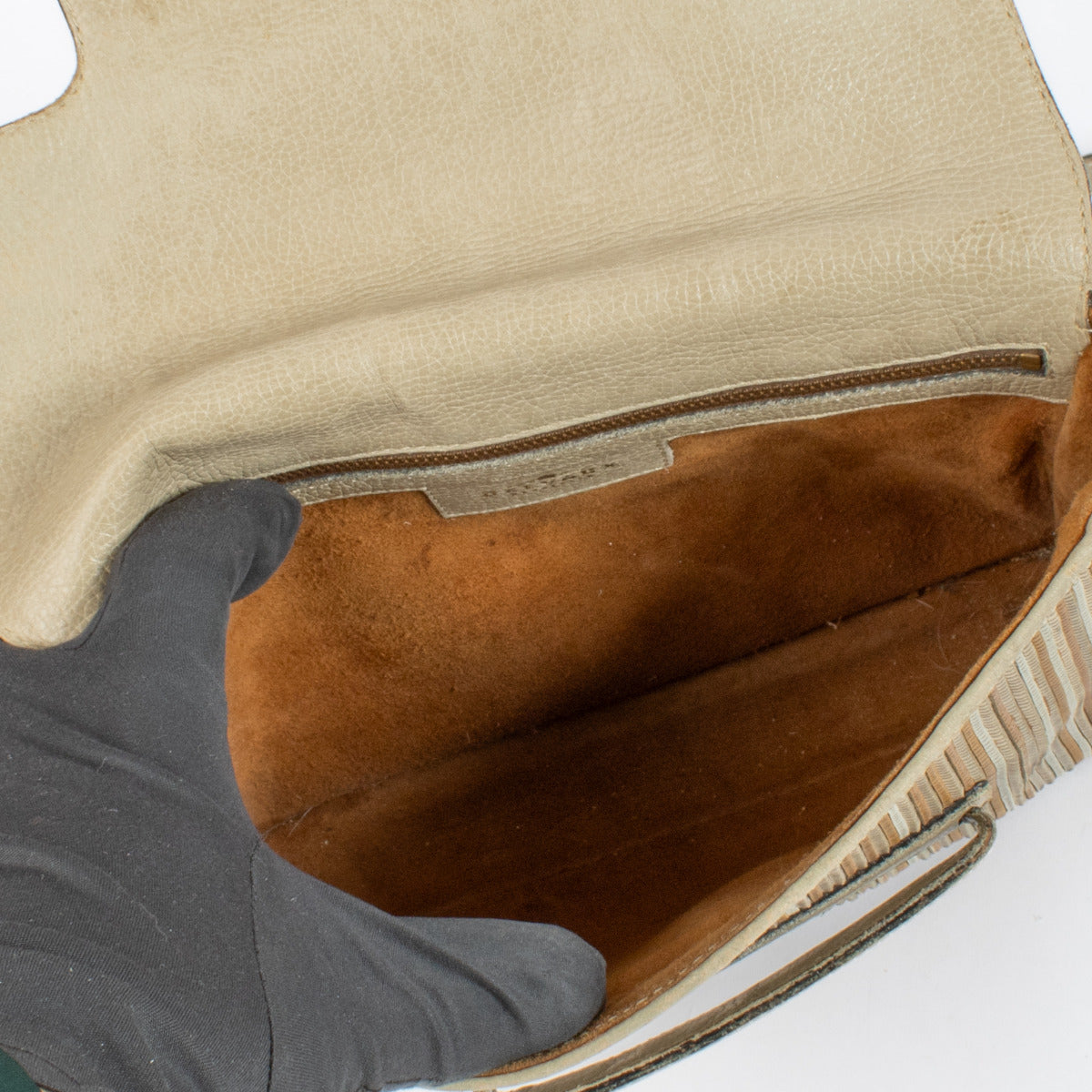 Interior of Delvaux Toile de Cuir Malbec bag with spacious compartment for daily essentials.
