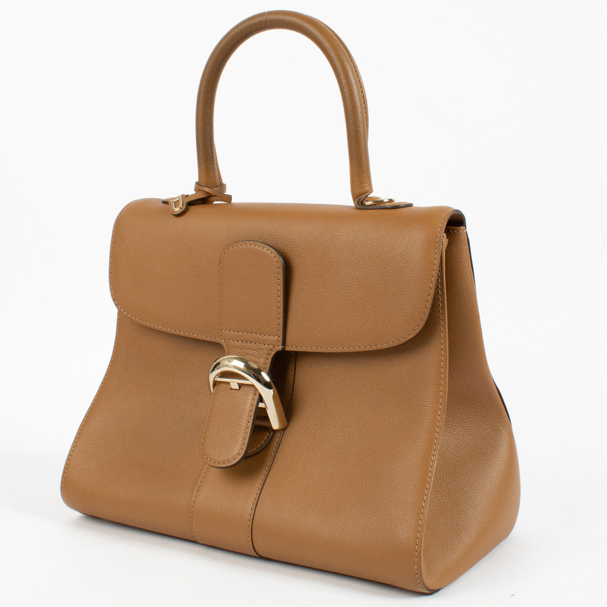 Side view of Delvaux cognac Brillant bag with smooth grain texture and structured flap.