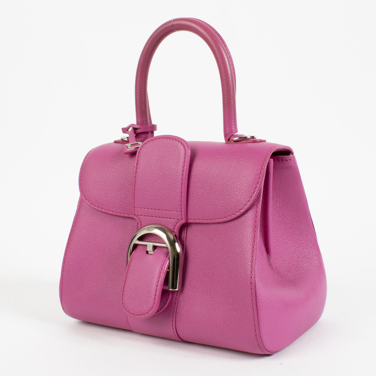 Side profile of heliotrope Delvaux bag with removable chain strap for versatile styling.
