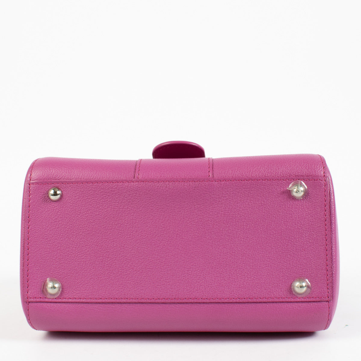 Lifestyle shot of Delvaux Heliotrope Brillant Mini styled with a monochrome outfit for a pop of color.