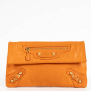 authentic preloved Balenciaga Orange Lambskin Motocross Giant Clutch on Labellov.com