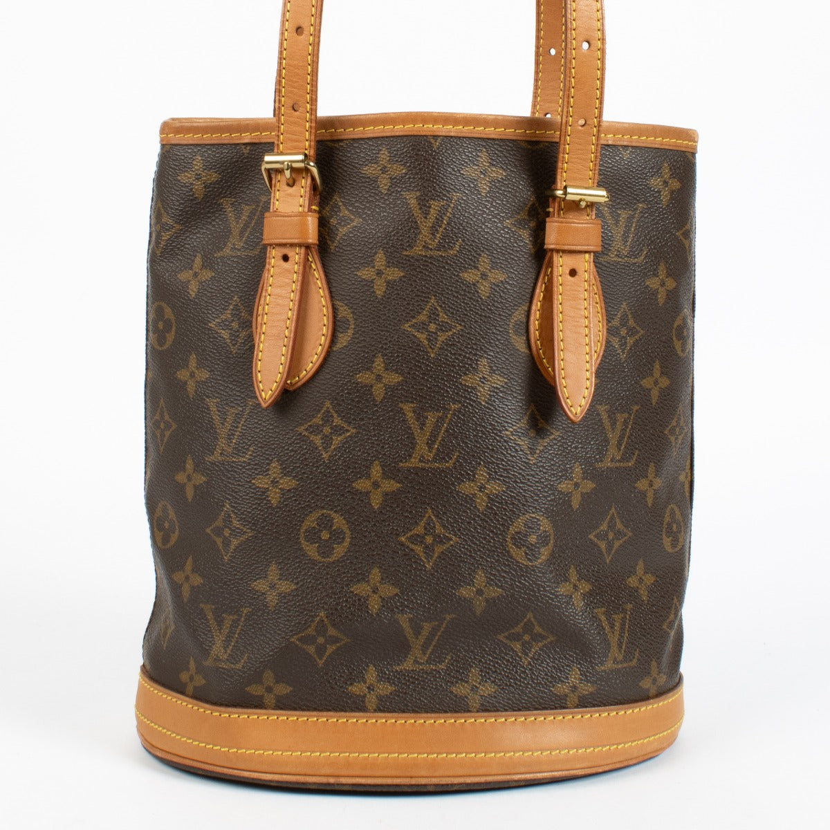 Authentic Louis Vuitton Petit Bucket bag in Monogram canvas with vachetta leather trim at Labellov.com